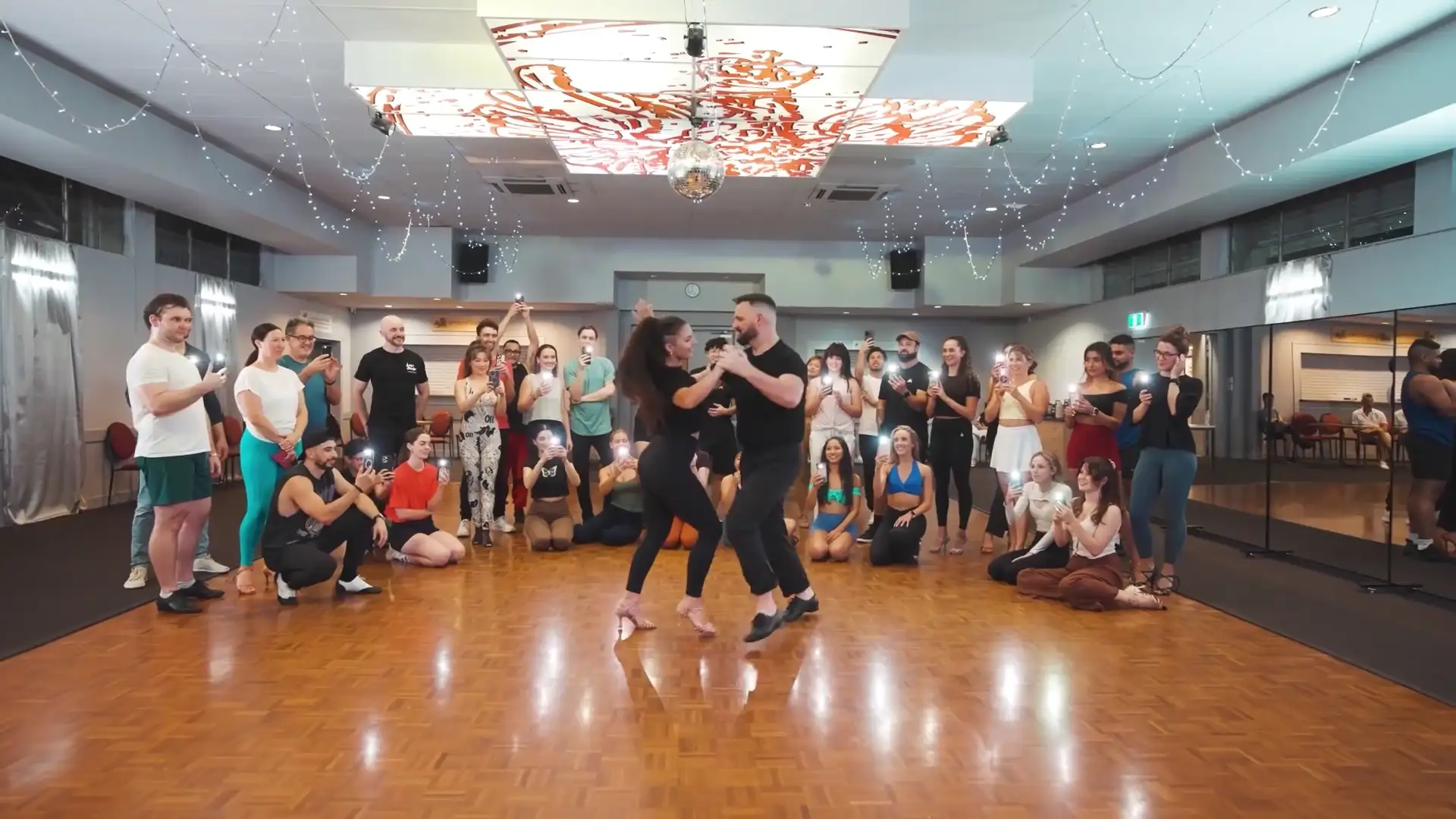 The class circled round to watch a demo dance
