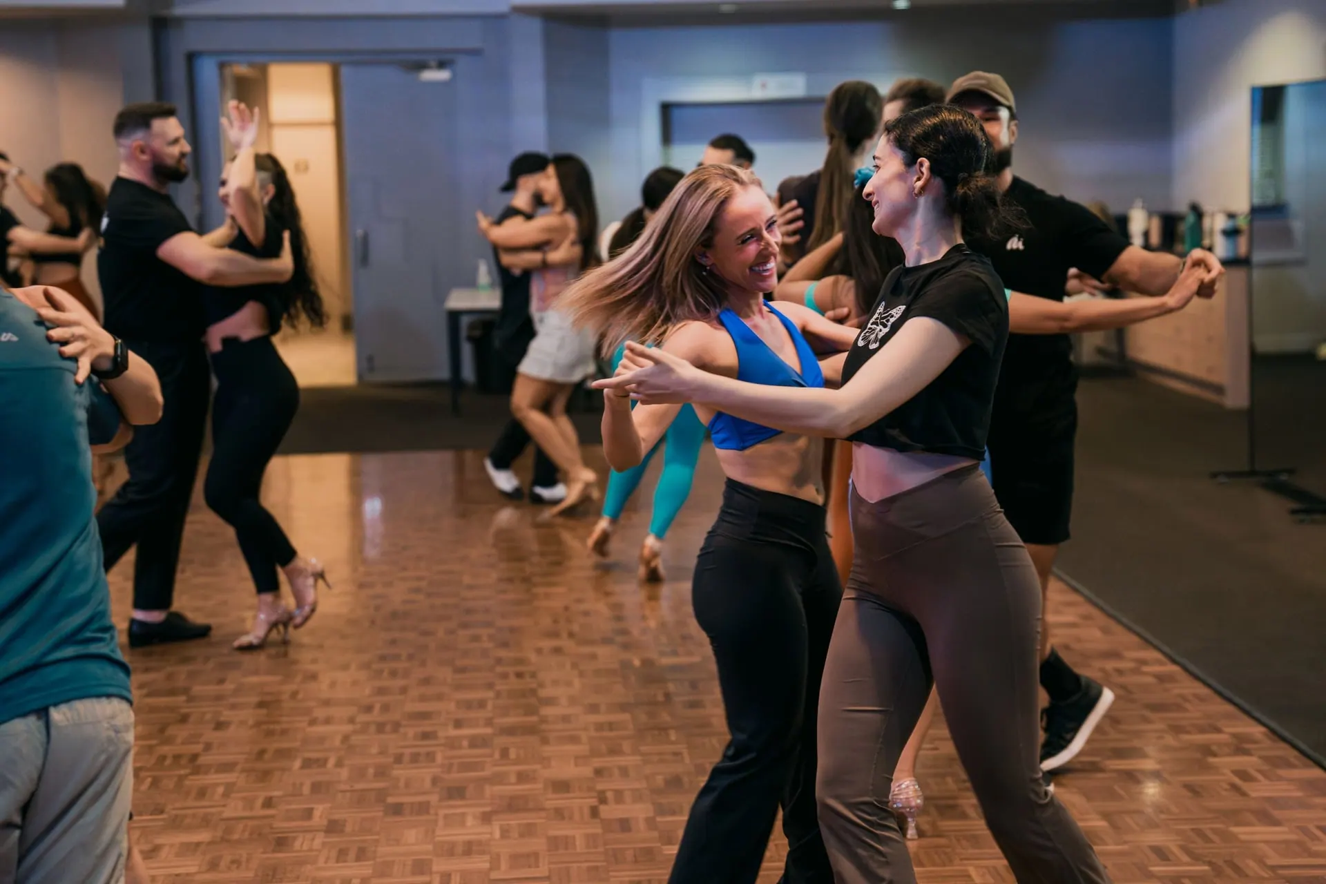 Students laughing mid-turn in a LocoMojo class